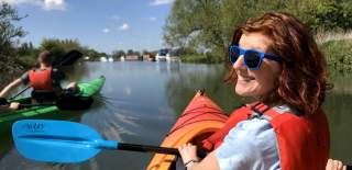 A couple kayaking on the River Thames at Lechlade with Cotswold Canoe Hire