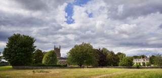 View across fields towards Kingham church