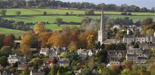 The town of Painswick with towering steeple, surrounded by autumnal countryside