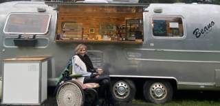 Heidi by a food van in her wheel chair