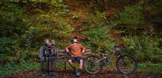 man sitting on a bench after a bike ride at Tarka Trail