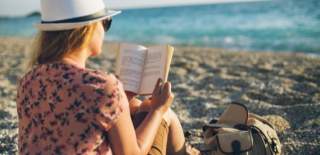 woman reading on the beach