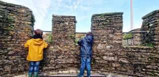 two boys on a castle tower looking out