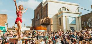A large crowd watching an acrobatics performer at the Freedom Festival