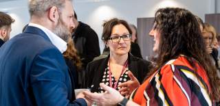 a networking event where a business support advisor is speaking with businesses.