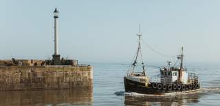 A small fishing trawler arriving at Bridlington harbour