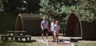 A family walking through a glamping site in East Yorkshire