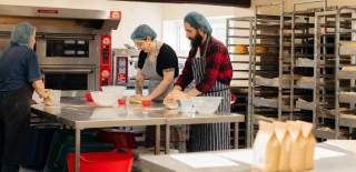 Two people taking part in a bread making workshop at Side Oven Bakery in East Yorkshire.