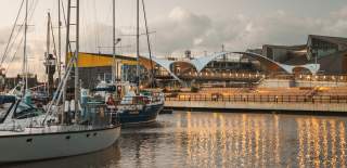 Hull Marina lit up on an evening with Murdoch's Bridge in the background.