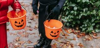 Two children trick or treating at Halloween