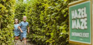 Two children running through the maze at Honeysuckle Farm near Hornsea