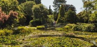 A couple admiring the impressive lake at Burnby Hall Gardens in Pocklington, East Yorkshire