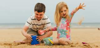 Two children building sandcastles on Bridlington's south beach