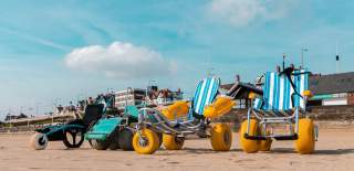 Adapted accessibility wheelchairs lined up on Bridlington Beach.