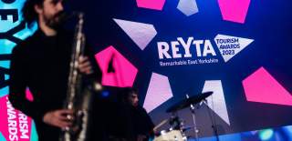A saxophonist playing at the REYTAs 2023