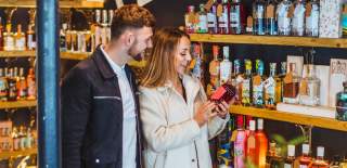 A couple looking at a bottle in a shop in Market Weighton
