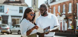 Couple looking over a Beverley map in Saturday Market