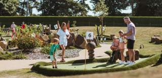 Family playing Crazy Golf at Dacre Lakes