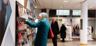 A lady choosing leaflets at Beverley TIC