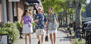3 people walking down the street