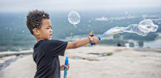 Kid playing with bubbles
