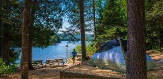 campground near a lake with a tent
