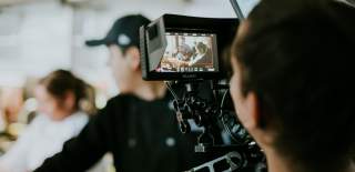 A camera crew films people.