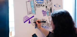 An artist at the cultural tides conference, visually representing the conversations that are taking place