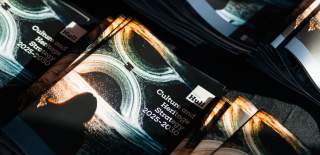 A stack of printed Culture and Heritage Strategy documents with the sunlight shining on them.