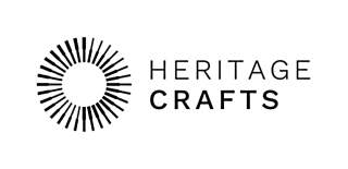 The Heritage Crafts logo. Heritage crafts is in black text on a white background. On the left side is a black wheel with black brushes and tools as black outline drawings in a circle.