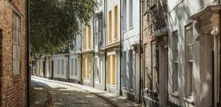 An shot from the historic Prince Street featuring colourful houses and cobbled streets.