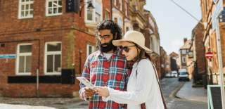 A couple looking at one of Hull's guides near the museums quarter.