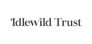 The Idlewild Trust logo. Idlewild Trust is in black writing with a white background.