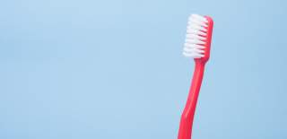 toothbrush in front of blue background