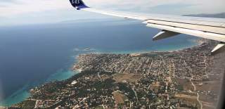 Airplane wing with a view down to Earth