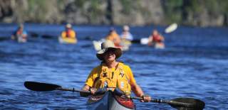 A man paddling a kayak in the Haldenkanalen.