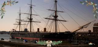 A dusky photograph of HMS Warrior, with festive images surrounding it