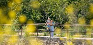 A grandparent and grandchild looking out over the water at Hilsea Lines