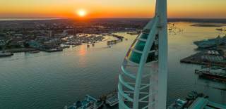 The sun sets behind Spinnaker Tower and Portsmouth Harbour