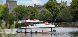 Le Boat cruising on the Thames in front of Windsor Castle