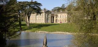 A view of Compton Verney on a clear day from across the lake