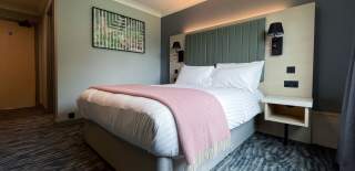 An image of a hotel bedroom at Warwick Conferences Scarman