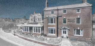 A wintery, snowy front view of the Arden Hotel in Stratford-upon-Avon