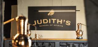 A rum distillery with a Judith's Sign in the background