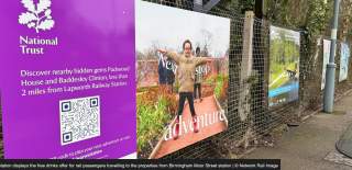 A National Trust poster on railway station platform