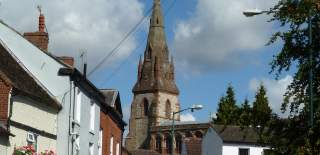 A picture of a church and buildings in Southam