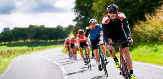 Group of males in a cycling race on a country road