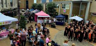 Choir singing in centre of Carlton Place with large crowd gathered to listen