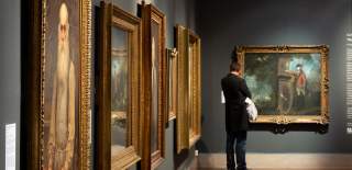 Person looking at peices of art at Southampton City Art Gallery