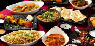 Top view of indian food dishes on a table at Mint Dosa